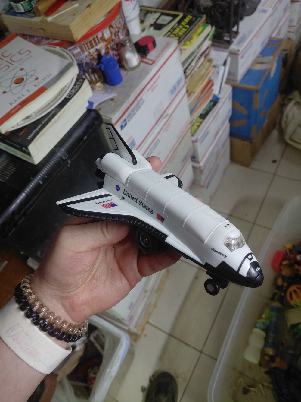 die-cast metal Space Shuttle Discovery toy featuring plastic landing gear wheels